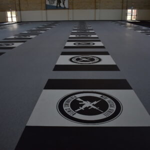2018-11-14 23.09.45 Indoor commercial weight room flooring completed installation with company logo.