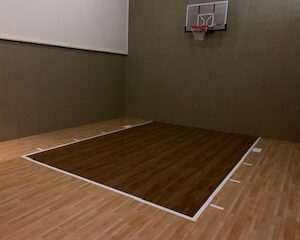 Indoor residential synthetic sports floor with brown wood colors.
