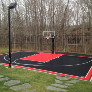 outdoor black and red half court in a backyard