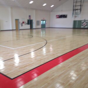 Indoor basketball court with shiny sports flooring.