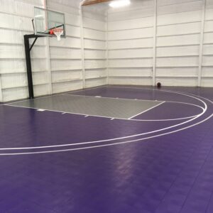 Indoor basketball court with purple and gray indoor sport tiles.