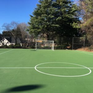Commercial outdoor soccer court with green court flooring.