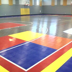 Kennesaw charter school indoor gymnasium with multi-colored flooring.