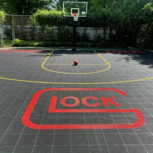 Outdoor basketball court with outdoor tiles and a lock logo.