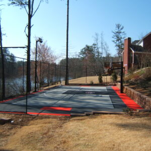 Residential outdoor basketball court with University of Georgia logo on court.