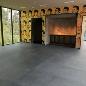 New exercise room flooring installation with Muhammad Ali on the wallpaper on the wall of the gym.