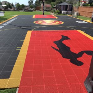 Outdoor residential basketball court with multiple hoops and the Atlanta Hawks branding.
