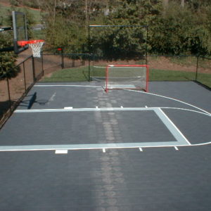 residential backyard basketball court that is fenced in